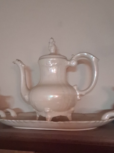 White ceramic lusterware teapot with iridescent finish and gold accents