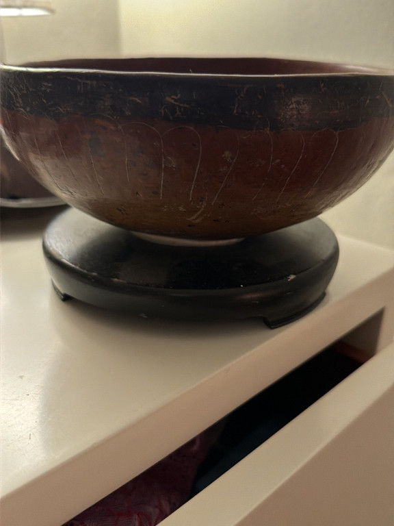 Wooden pedestal bowl with dark finish and incised decoration