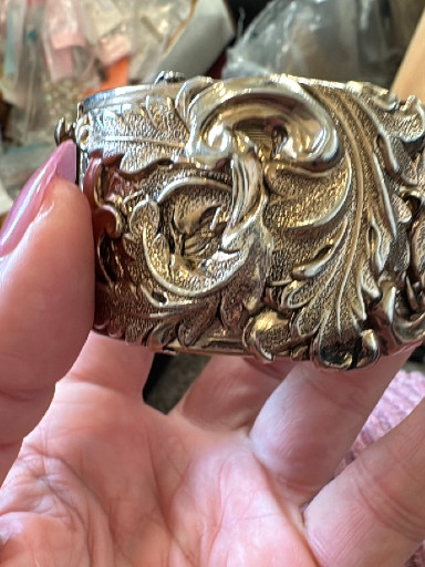 Silver-tone hinged clamper bracelet with repousse floral and scroll design by Whiting & Davis
