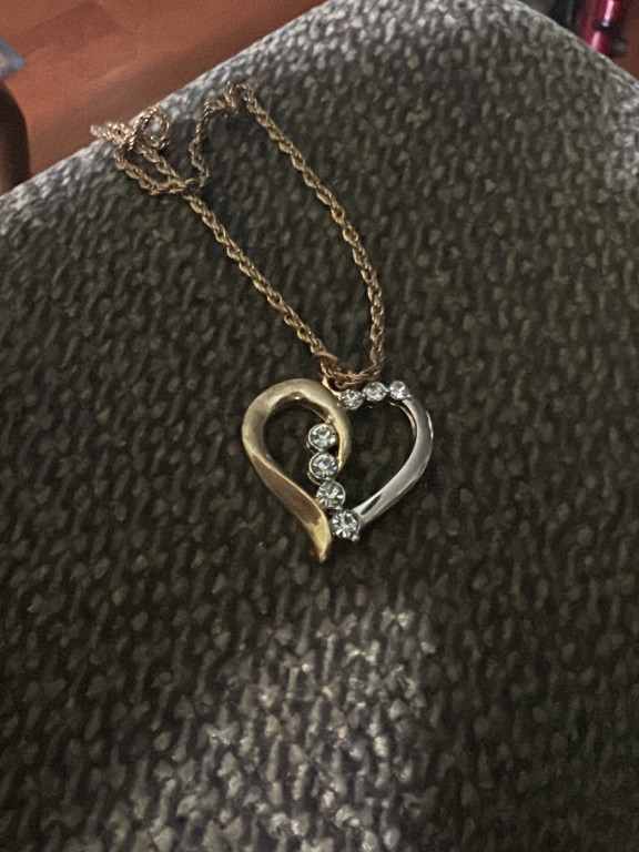 Gold and silver tone heart pendant necklace with diamond or crystal accents
