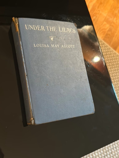 Hardcover book titled 'Under the Lilacs' by Louisa May Alcott