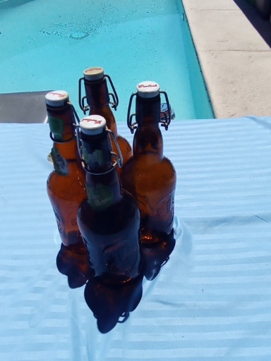 Set of three vintage amber glass swing-top bottles with ceramic and wire bail closures