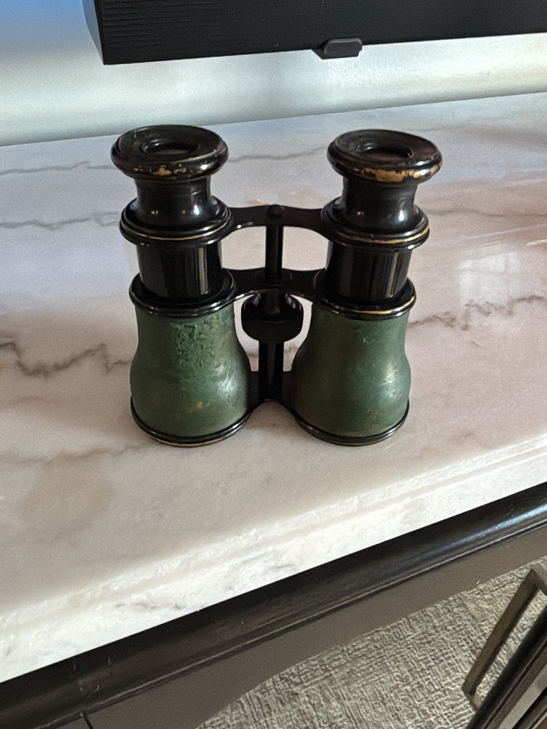 Antique opera glasses with green leather and brass body