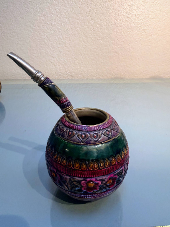 Hand-carved gourd mate cup with metal bombilla straw, handmade in Argentina