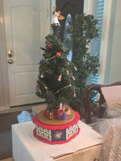 Vintage musical rotating Christmas tree advent calendar with decorative base
