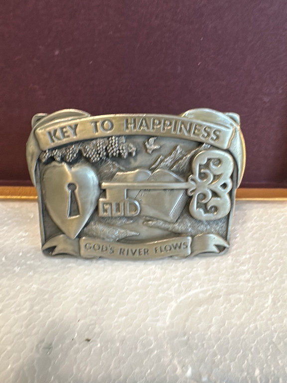 Brass belt buckle titled 'Key to Happiness' by Bergamot Brass Works