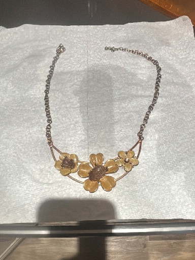 Costume jewelry statement necklace with peach-colored enamel flowers