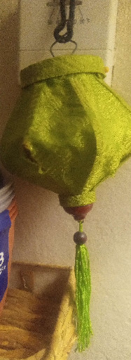 Decorative silk lantern in bright yellow-green with tassel