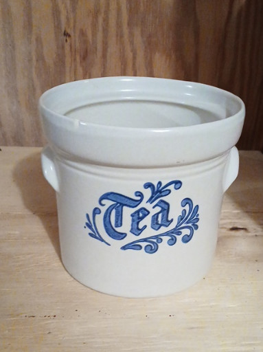 Stoneware tea canister from the 'Yorktowne' pattern by Pfaltzgraff. Small chip on front top and no lid.