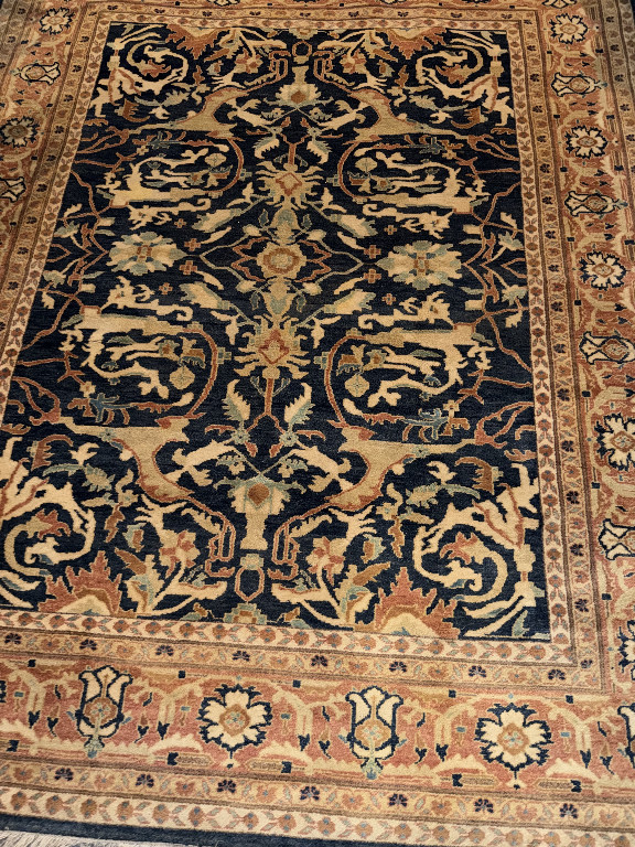 Hand-knotted Persian wool area rug with floral and vine motifs