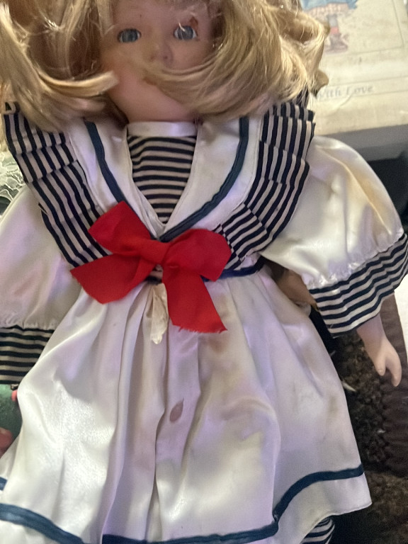 Porcelain doll in sailor dress with blonde hair