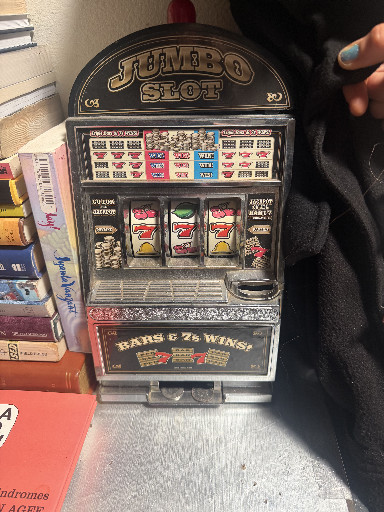 Novelty slot machine coin bank titled 'Jumbo Slot Bars & 7s Wins'