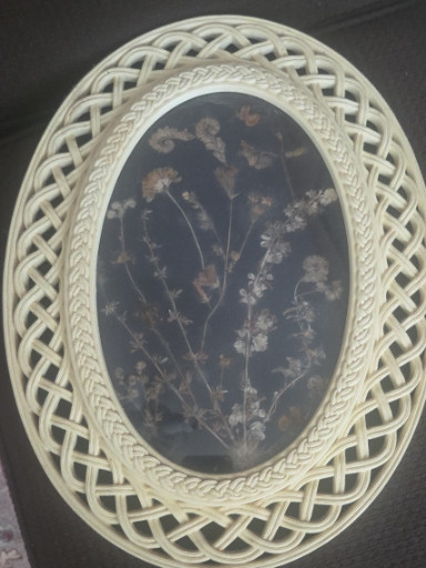 Pressed flower art in vintage faux wicker oval frame