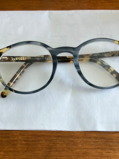 Acetate reading glasses with blue-tinted lenses and tortoiseshell temple arms by Millicent Bryce
