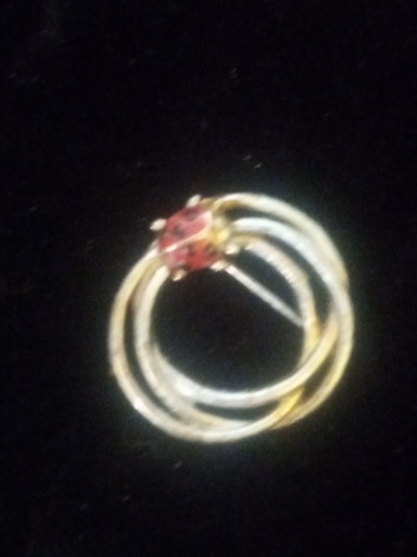 Gold-tone enamel ladybug brooch with pink rhinestone accents