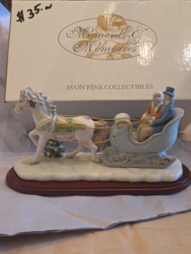 Porcelain figurine titled 'Moments & Memories Sleigh Ride' by Avon