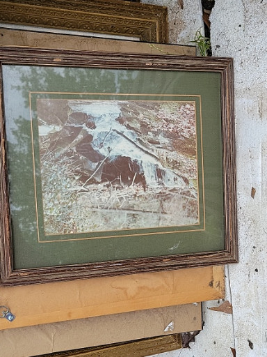 Framed print depicting a waterfall landscape