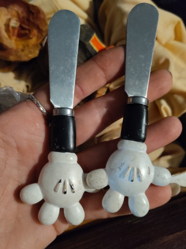 Pair of stainless steel butter spreaders with Mickey Mouse glove handles by Disney