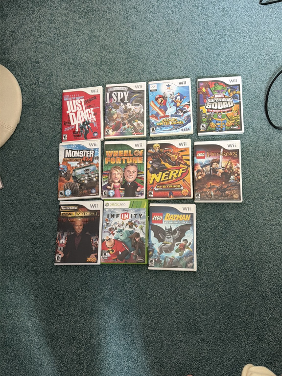 Collection of eleven Nintendo Wii video games including 'Just Dance', 'I Spy', 'Mario & Sonic at the Olympic Winter Games', 'Super Mario Galaxy', 'Monster Jam', 'Wheel of Fortune', 'Nerf N-Strike', 'LEGO Lord of the Rings', 'WWE SmackDown vs. Raw', 'Disney Infinity', and 'LEGO Batman'
