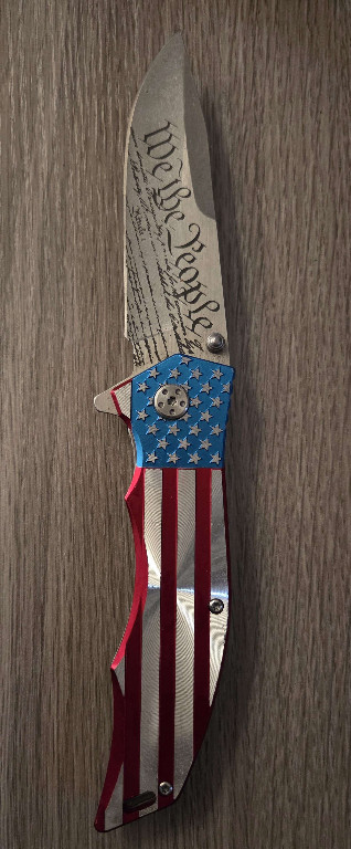 Folding pocket knife with American flag design and Constitution text engraving