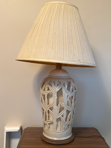 Ceramic table lamp with incised bamboo leaf pattern and pleated fabric shade