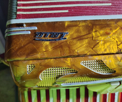 Piano accordion with golden pearloid finish by Titano Trio