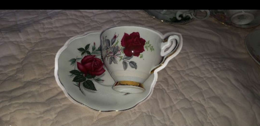 Bone china teacup and saucer in 'Roses to Remember' pattern by Royal Stafford