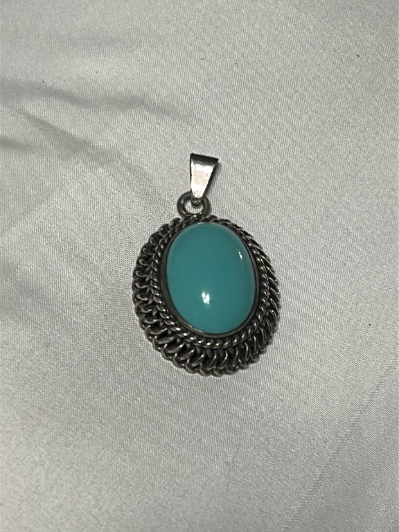 Sterling silver pendant with turquoise cabochon and rope design border