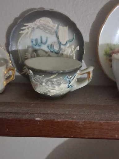 Porcelain moriage dragonware teacup and saucer with raised dragon decoration