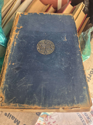 Antique book with Chinese longevity symbol embossed on blue cloth cover