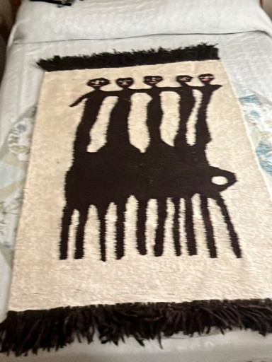 Hand-woven wool wall tapestry depicting stylized African figures