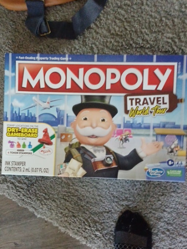 Hasbro board game 'Monopoly Travel World Tour' with dry-erase gameboard and token stampers