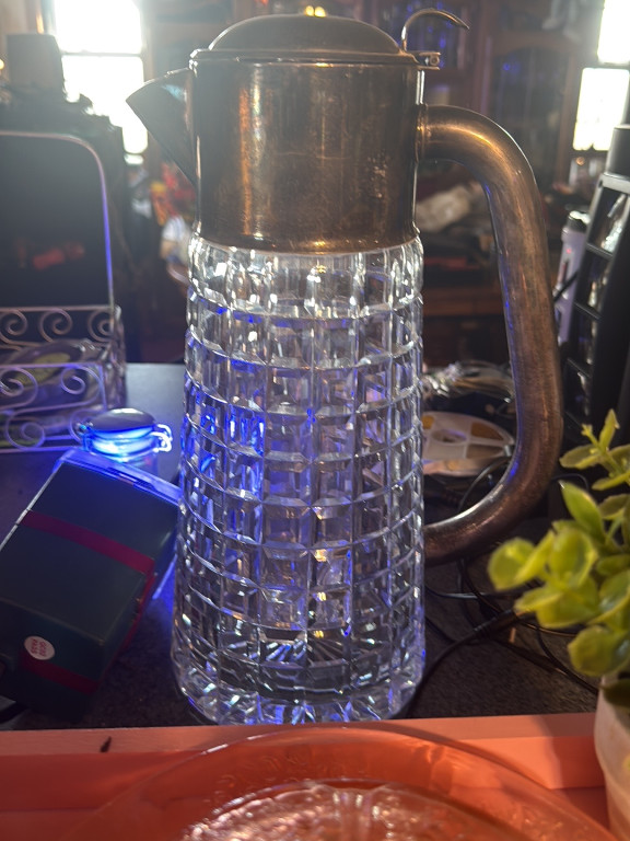 Cut crystal pitcher with silver-plated lid and handle