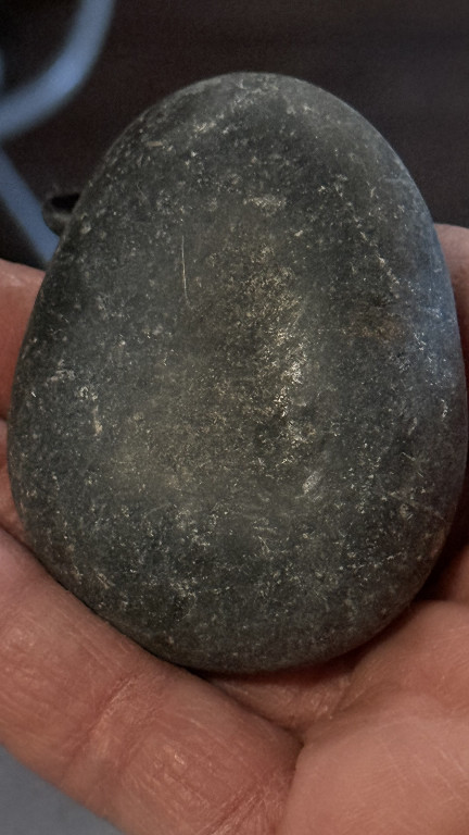 Stone egg-shaped object, possibly a decorative or ceremonial stone egg