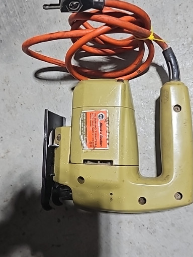 Vintage electric jigsaw (sabre saw) in yellow housing, circa 1960s-1970s
