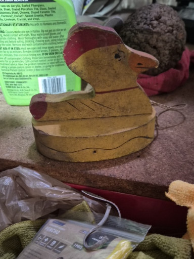 Vintage wooden duck pull toy with painted yellow and red details