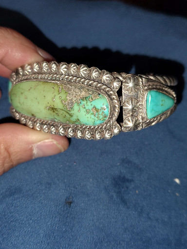 Sterling silver cuff bracelet with turquoise stones by Navajo artisan