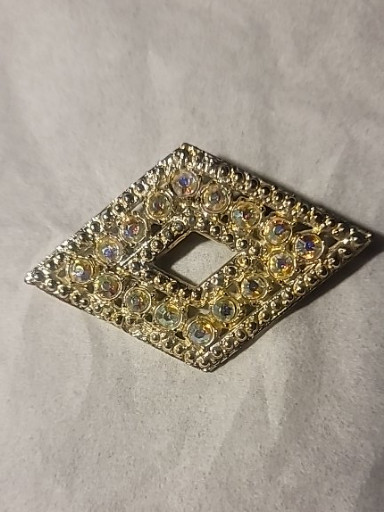 Gold-tone metal brooch with aurora borealis rhinestones in diamond shape
