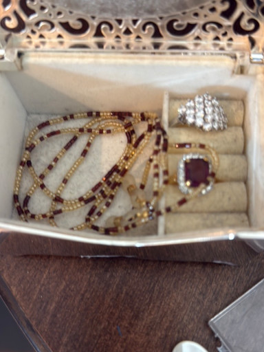 Vintage jewelry set including garnet and gold-tone beaded necklace, matching ring, and rhinestone cocktail ring