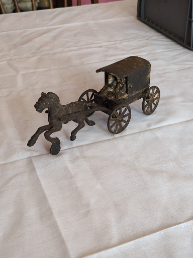 Cast iron toy horse-drawn wagon with driver figure