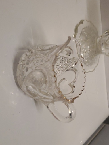 Pressed glass creamer with floral etching and scalloped rim