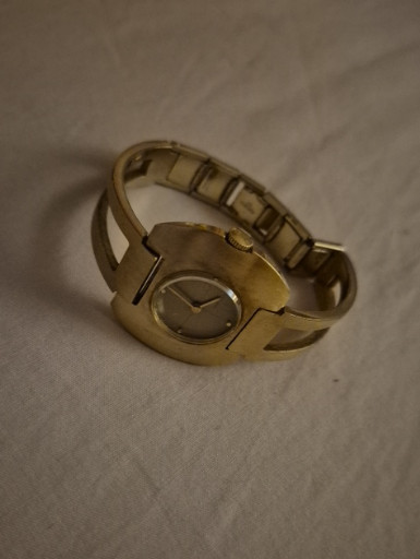 Gold-tone bangle watch with oval dial and expandable bracelet