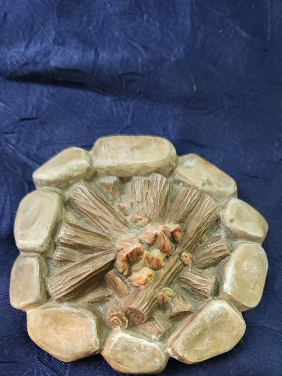 Ceramic campfire surrounded by rocks.