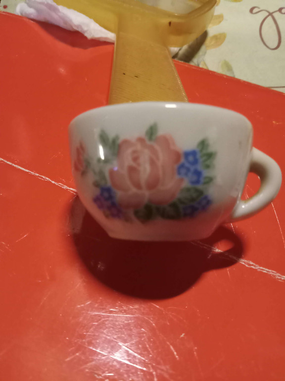Porcelain miniature teacup with pink rose and blue flower decoration