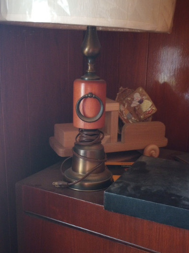 Wood and metal table lamp with ceramic shade featuring circular motif