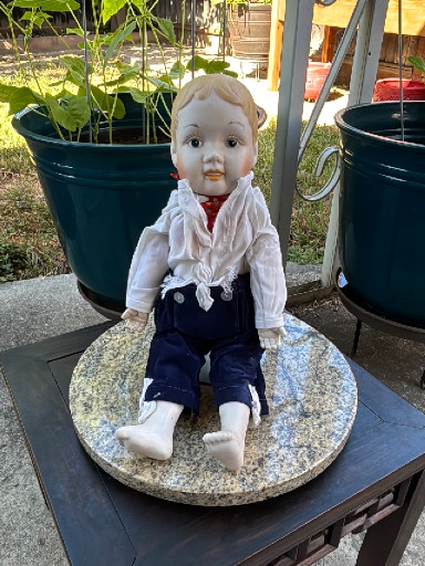 Bisque porcelain character boy doll, likely of German origin.