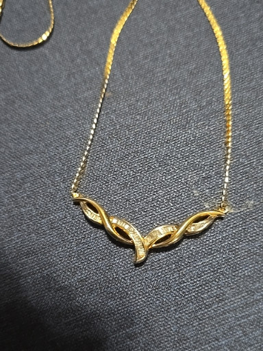 14K yellow gold necklace with diamond-set ribbon or chevron pendant
