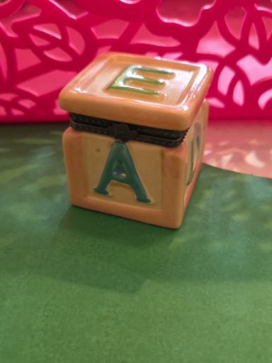 Porcelain hinged trinket box shaped like a baby alphabet block with letters 'E' and 'A'