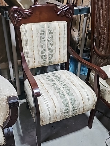 Mahogany Victorian-style armchair with carved crest rail and floral upholstery