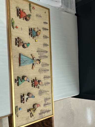 Framed folk art print depicting stylized figures in traditional dress